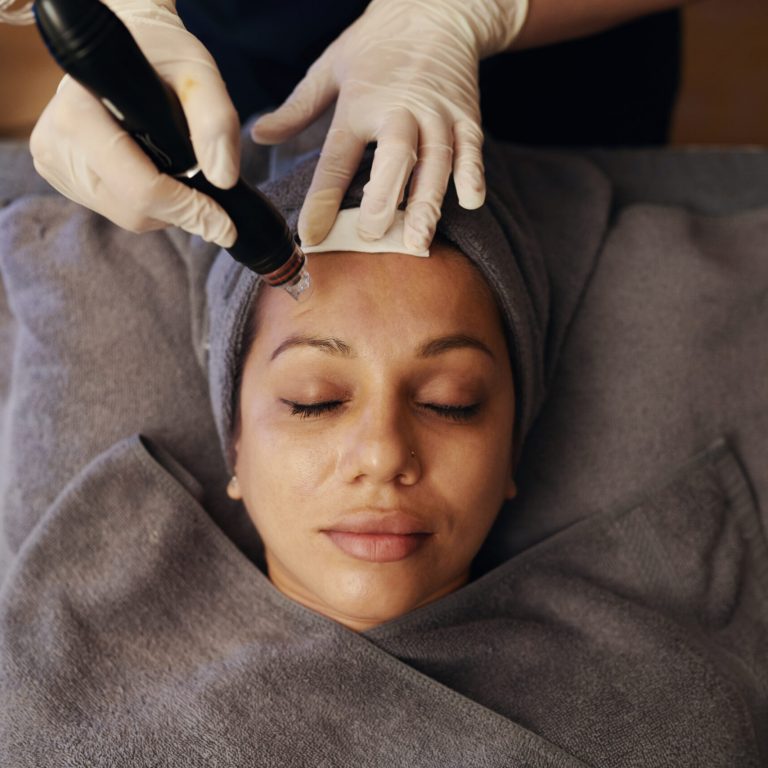 Calm woman visiting cosmetologist to get beauty procedure, top view